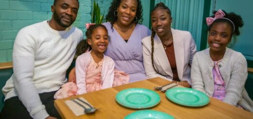 a group of people sitting around a wooden table
